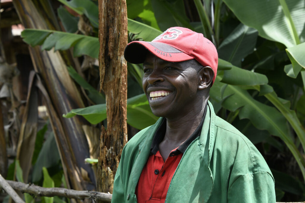 En mörkhyad man som ler stort.