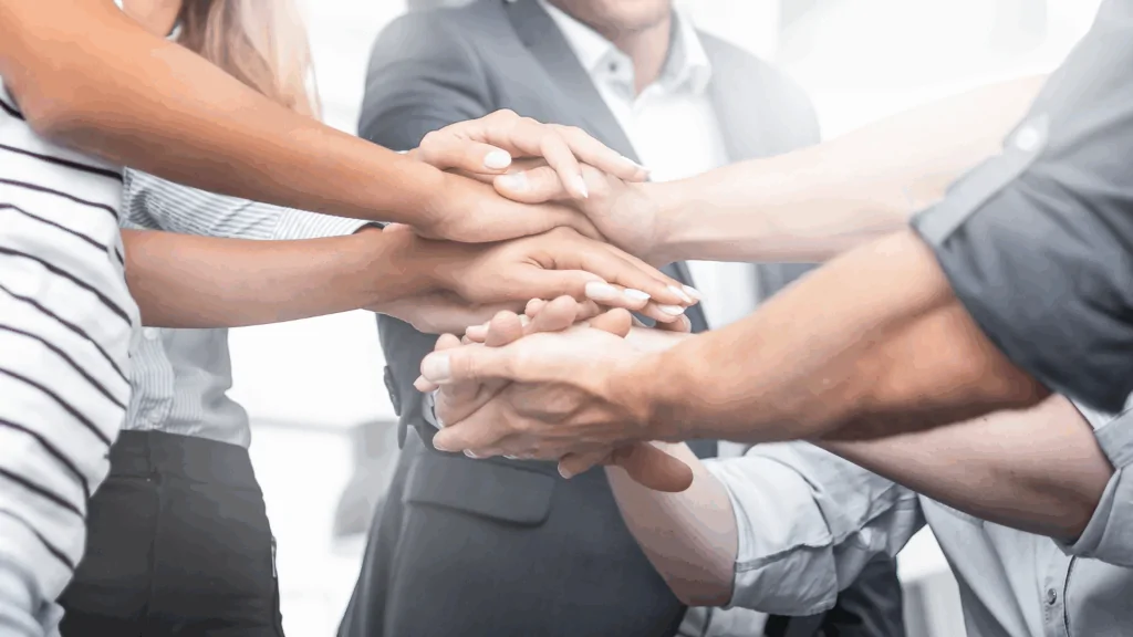 A group of people holding hands.